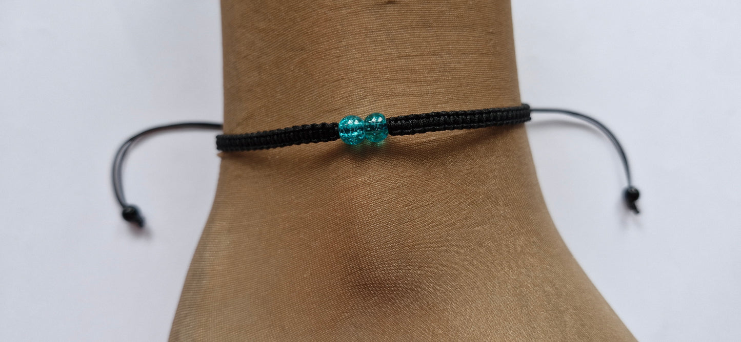 Turquoise bead anklet, handmade using 2 turquoise crackle glass beads on black woven cord and black beads on the ends of the cords.  The anklet is adjustable, so fits all ankle sizes