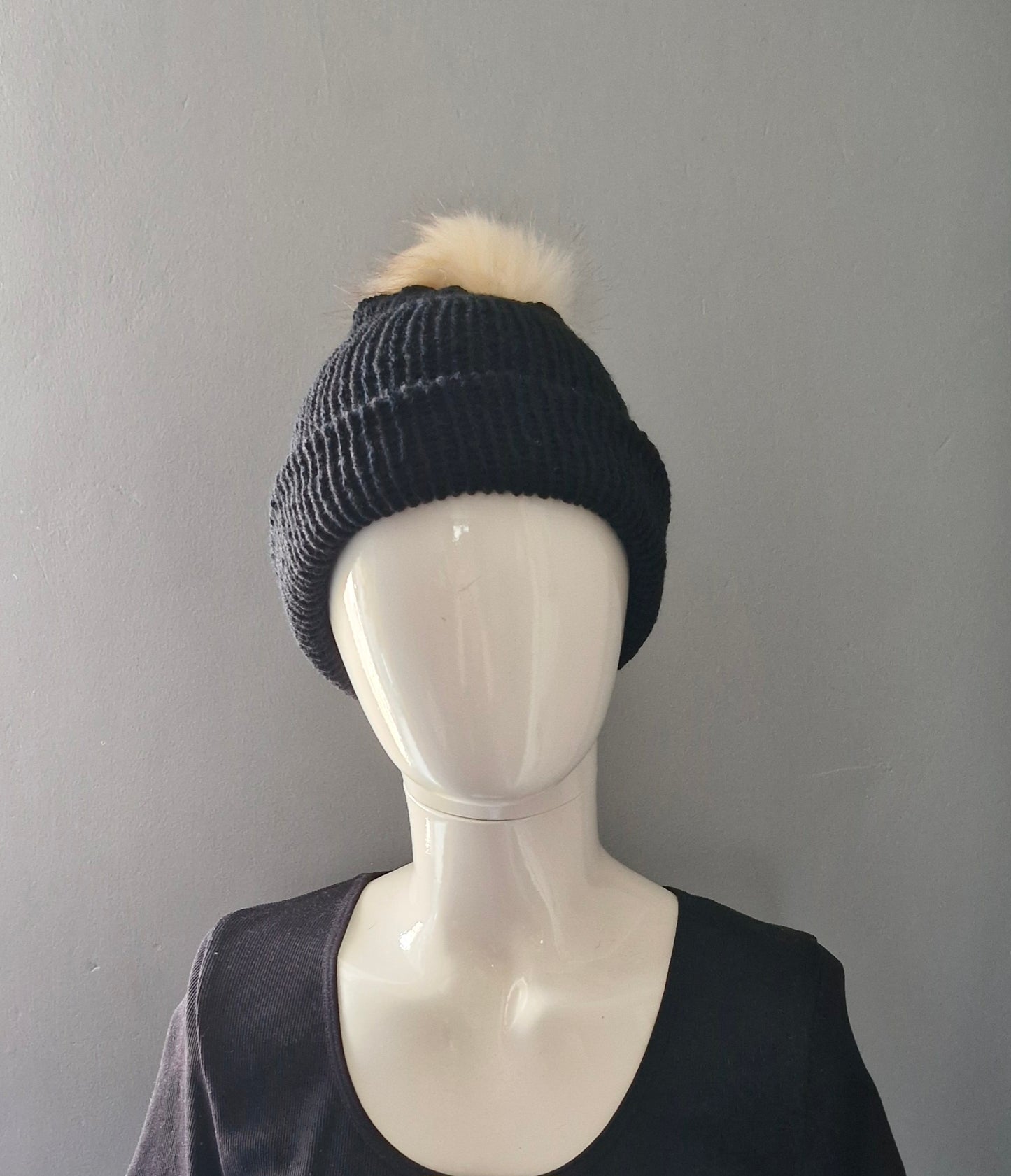 Black beanie hat with cream coloured pom pom