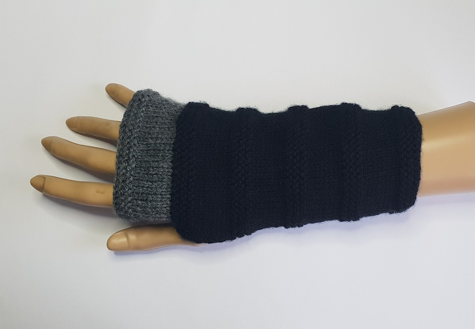 Black and grey fingerless gloves.  Mainly black with grey at the top , hand knit fingerless gloves..