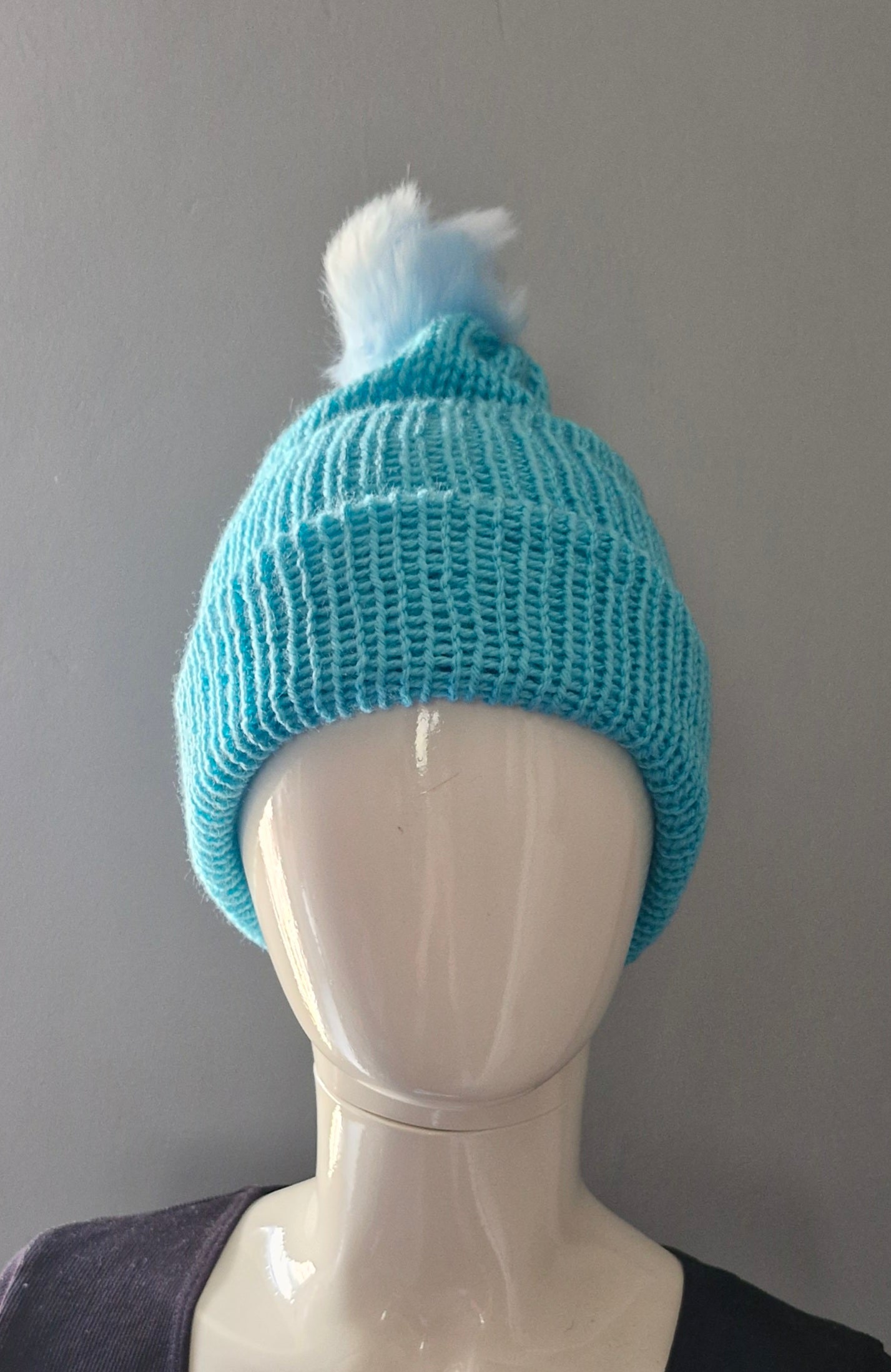 Blue beanie hat with light blue pom pom