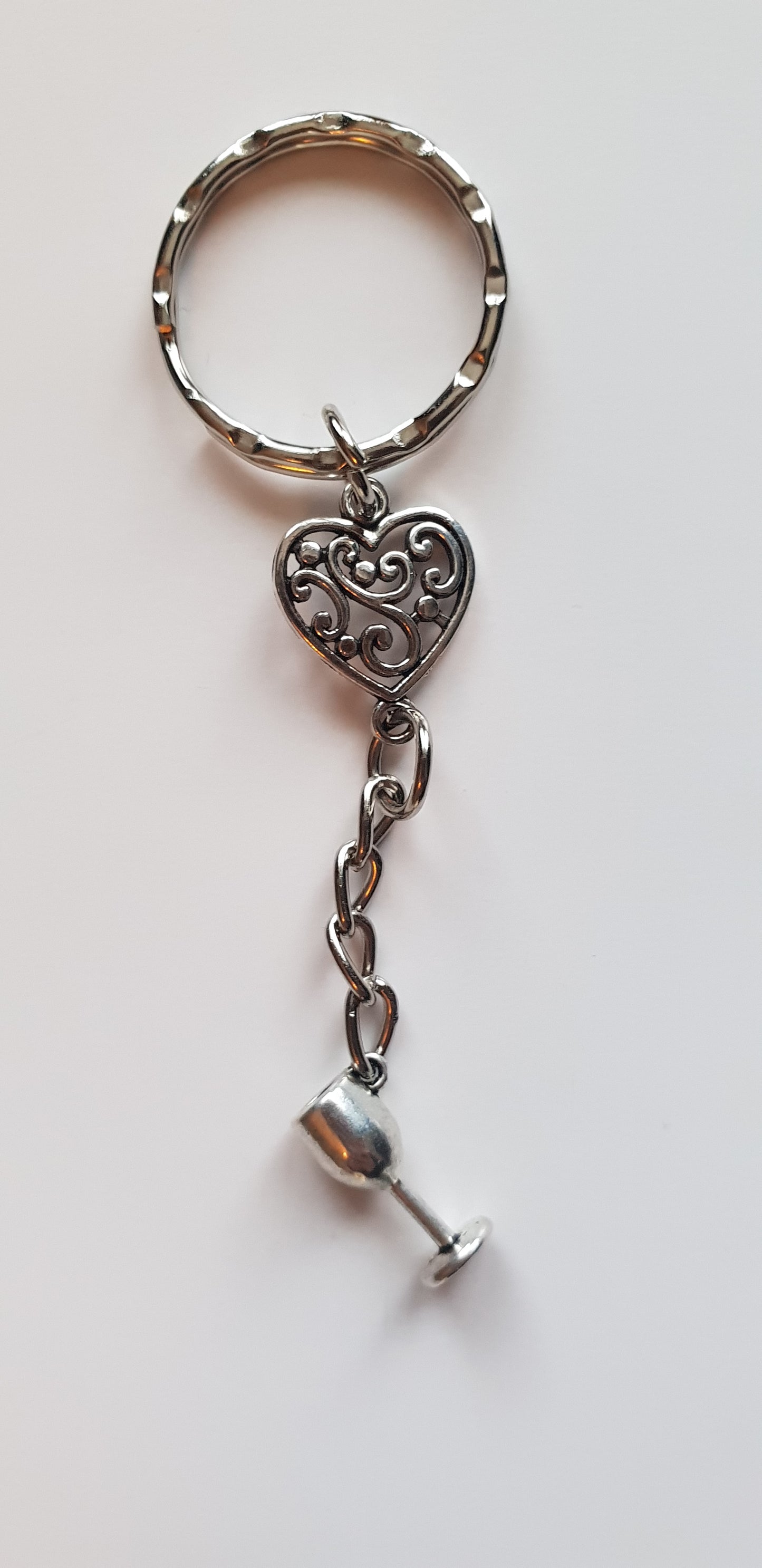 Love wine keyring, handmade using a tibetan silver heart charm with an alloy wine glass charm, hanging from a keyring hoop.