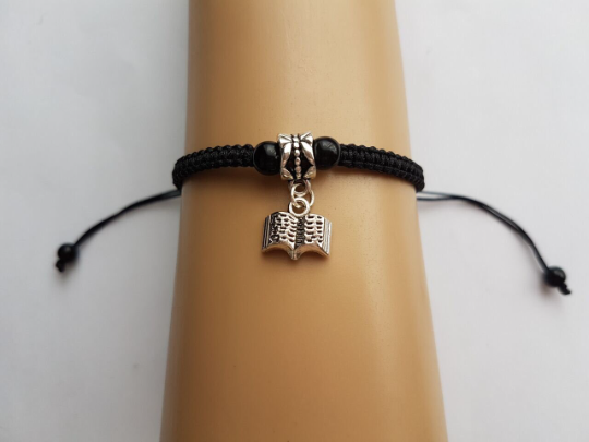 This book charm bracelet would make a great book lover gift.  Available with black, white or red beads.  Handmade using black cord with coloured beads either side, with black beads on the ends of the cords.  This bracelet is adjustable, so suitable for all wrist sizes.